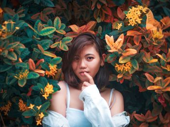 Portrait of a beautiful young woman with autumn leaves