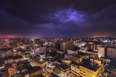 The clouds embrace the dark city and light it up with lightning