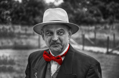 Portrait of man wearing hat standing outdoors