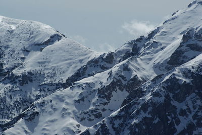 Scenic view of snowcapped mountain against cloudy sky