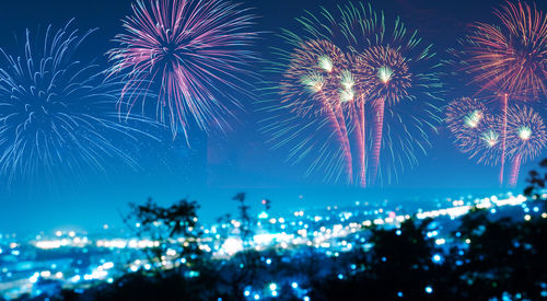 Low angle view of firework display against sky at night