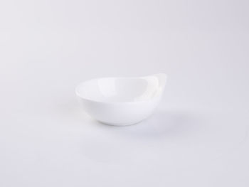 Close-up of empty glass against white background