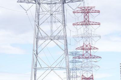 Low angle view of electricity pylon against sky