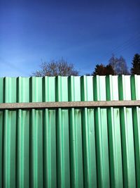 Low angle view of fence against sky