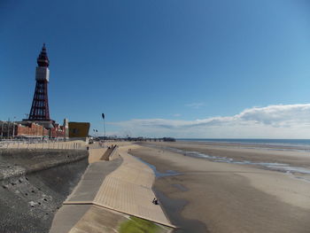 Scenic view of beach against blue sky