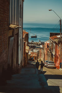 People walking on street amidst buildings in city