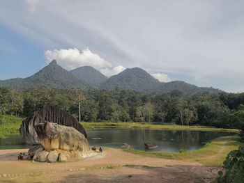 Scenic view of lake and mountains against sky