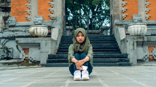 Portrait of teenage girl sitting on staircase