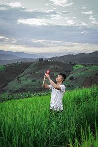 Full length of man standing on field against sky