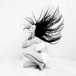 Midsection of woman with arms raised