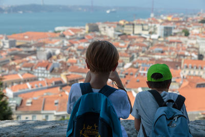 Rear view of boy looking at cityscape