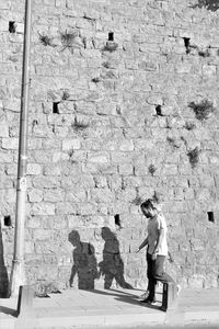 Full length of man standing on footpath