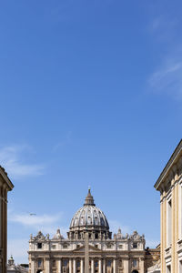 Low angle view of vatican city against blue sky