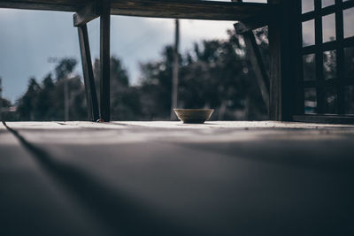 Close-up of glass on table against window