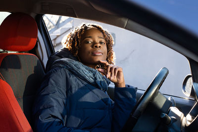 Portrait of smiling woman sitting in car