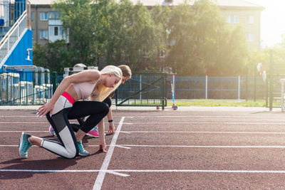 Low section of man exercising on field