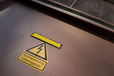 High angle view of warning sign on walkway