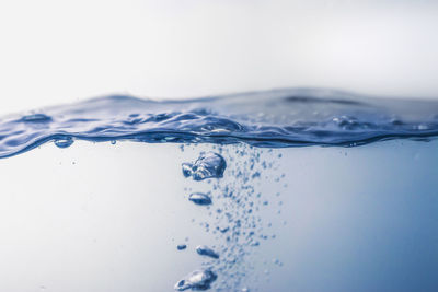 Close-up of water splashing against white background