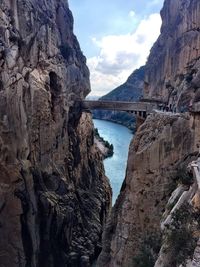 Scenic view of river by mountain against sky