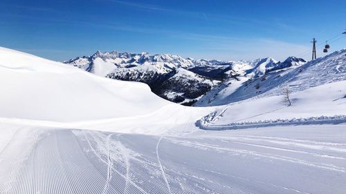 Scenic view of snow covered mountains against sky