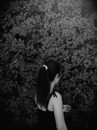 Woman standing by tree