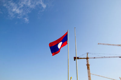 Low angle view of flag against blue sky