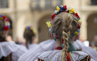 Rear view of women wearing flowers