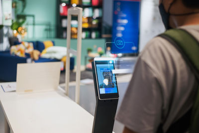 Midsection of man using mobile phone