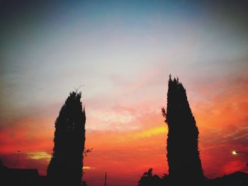 Low angle view of silhouette trees against sky during sunset