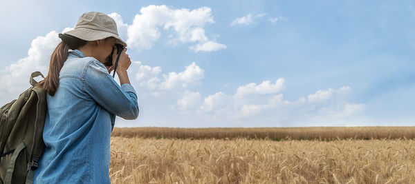 Man standing on field against sky