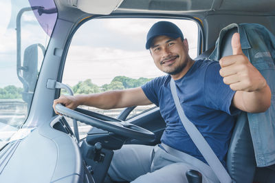 Portrait of young man sitting in car