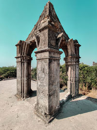 Archway of historic building against clear blue sky