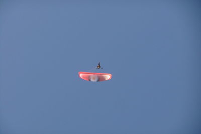 Low angle view of airplane flying in sky