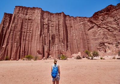 Rear view of man walking on rock