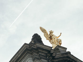 Low angle view of statue against sky