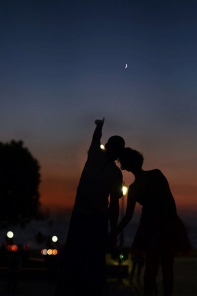 silhouette, sunset, lifestyles, men, leisure activity, sky, orange color, togetherness, person, illuminated, unrecognizable person, standing, night, holding, outdoors, dusk