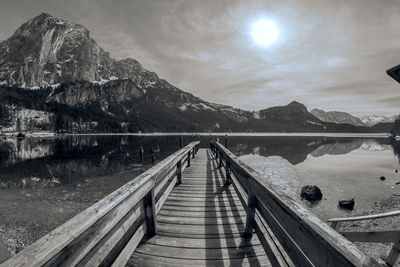 Scenic view of lake by mountains against sky