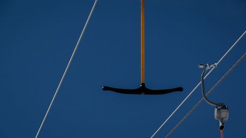 Low angle view of vapor trail against clear blue sky