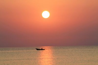 Scenic view of sea against orange sky