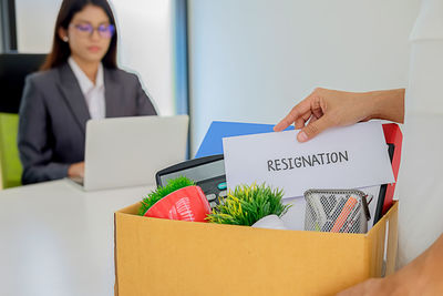 Colleagues with objects at desk in office