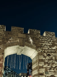 Low angle view of historic building against sky at night