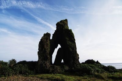 Low angle view of rocks on sea against sky