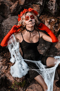 Closeup portrait of calavera catrina. young woman with sugar skull makeup and white spiderweb. dia 