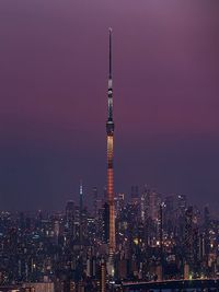 Illuminated cityscape against sky at night