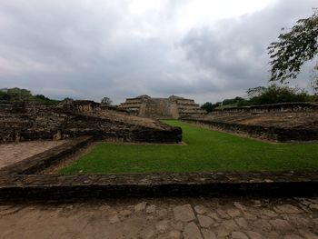 Old ruin on field against sky