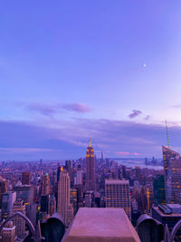 Buildings in city against cloudy sky