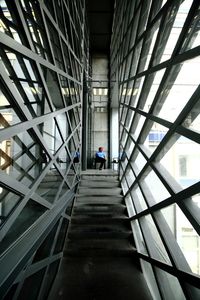 Rear view of man walking on steps