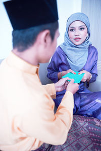 Husband and wife sharing gift during the eid festival