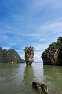 Rock formations by sea against sky