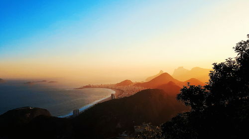 Scenic view of silhouette mountains against sky at sunset